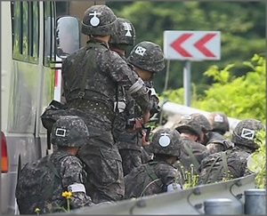 오전 강원도 고성군 현내면 명파리와 마달리 사이 도로에서 교전 총성이 들리자 수색팀 장병들이 차량에 엄폐한 채 상황을 지켜보고 있다.ⓒ연합뉴스