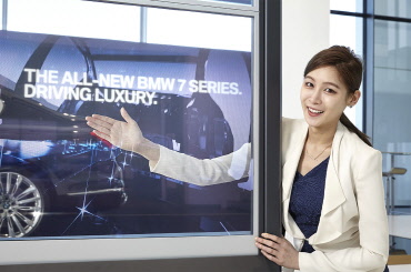 삼성전자 모델이 인천 영종도에 위치한 BMW 드라이빙센터에 새롭게 설치된 투명 OLED 디스플레이 비디오월을 소개하고 있는 모습.ⓒ삼성전자