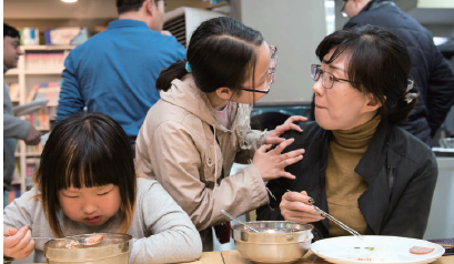 우정선행상 대상에 선정된 이정아씨가 청개구리식당에서 아이들과 식사를 하고 있는 모습[사진=코오롱그룹]