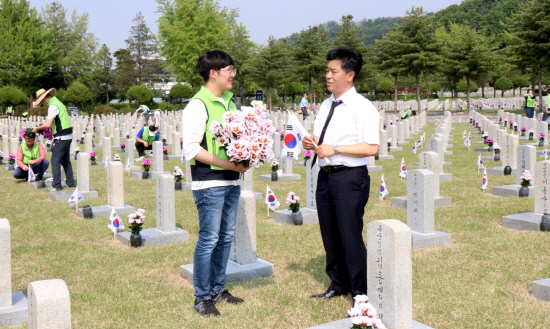 LIG넥스원 임직원들 22일 서울현충원 자매결연 묘역인 제30묘역을 찾아 정화활동을 펼쳤다. [사진=LIG넥스원]