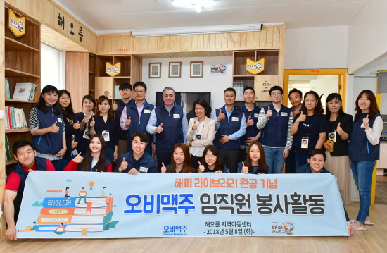 오비맥주 임직원이 8일 서울 송파구 ‘해오름 지역아동센터’를 찾아 여섯 번째 ‘해피 라이브러리’ 개관식에서 기념촬영을 하고 있다.