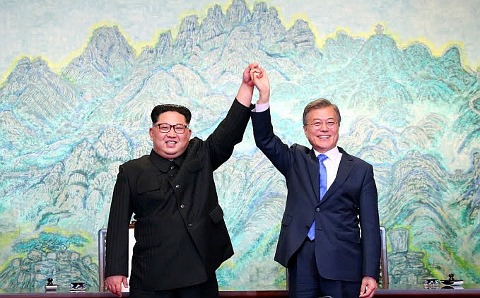문재인 대통령과 김정은 국무위원장이 지난 4월 27일 판문점 평화의 집에서 '판문점 선언문'에 사인한 뒤 함께 맞잡은 손을 높이 들고 있다ⓒ연합