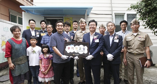 지난 7일 제주 소망지역아동센터에서 열린 '무지개교실'행사에서 KB증권 전병조사장(앞줄 오른쪽 세번째)과 최성목 해군 7기동전단장(뒷줄 오른쪽 세번째), 허경호 소망지역아동센터 대표(앞줄 오른쪽 네번째) 및 관계자들이 현판 전달식 후 기념촬영을 하고 있다. ⓒEBN