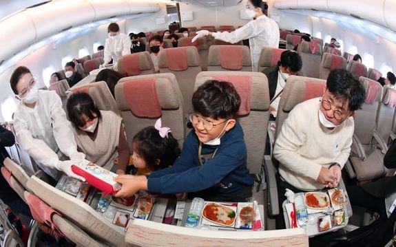 아시아나항공 'A380 한반도 일주 비행' 항공기에 탑승한 한 가족이 이륙 후 기내식 서비스를 즐기고 있다.ⓒ공항사진기자단