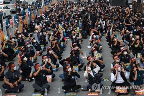 18일 공공운수노조 조합원들이 서울 강남구 하이트진로 본사 앞에서 열린 화물연대 고공농성투쟁 승리 결의대회에서 농성자들을 보며 격려하고 있다.ⓒ연합뉴스